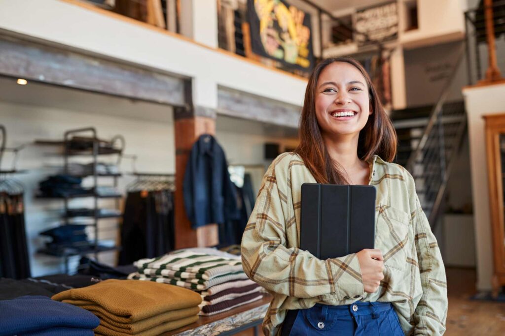 Female business owner smiling in retail store.