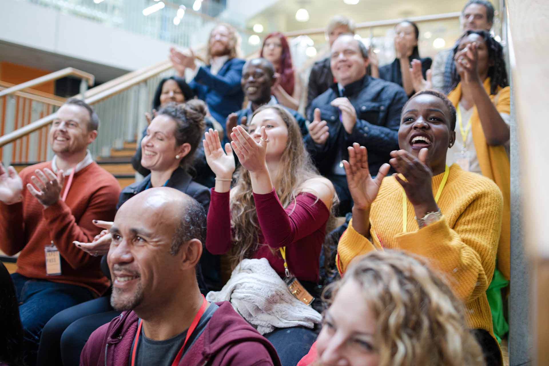 Enthusiastic audience clapping and cheering